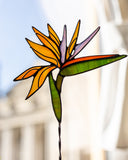 Stained glass bird of paradise flower with a blurred background