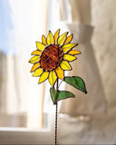 Stained glass sunflower decoration in front of a window
