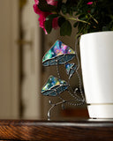 Decorative stained glass jellyfish on a wooden surface with a blurred background