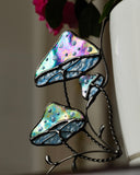 Decorative stained glass panel with leaf design on a blurred background