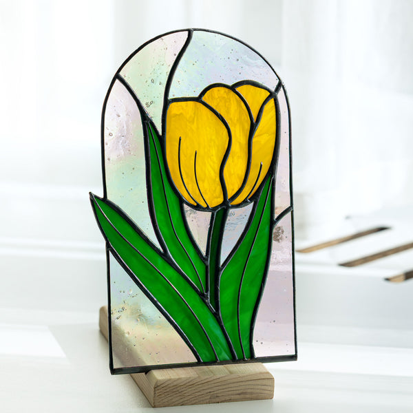 Stained glass panel with a yellow tulip on a white background