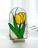 Stained glass panel with a yellow tulip on a white background