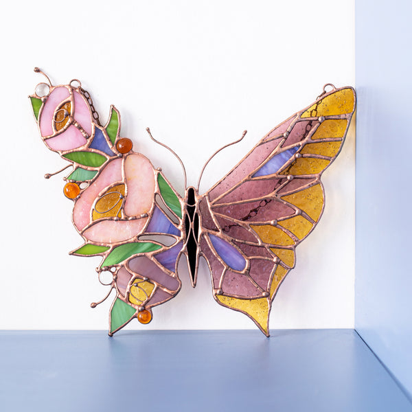 Handmade butterfly and flowers stained glass suncatcher in soft pink, crafted from high-quality glass, perfect for hanging in windows or on walls, ideal gift for nature lovers