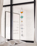 Decorative window sticker with colorful geometric design on a bedroom window